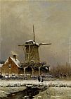 Figures by a windmill in a snow covered landscape